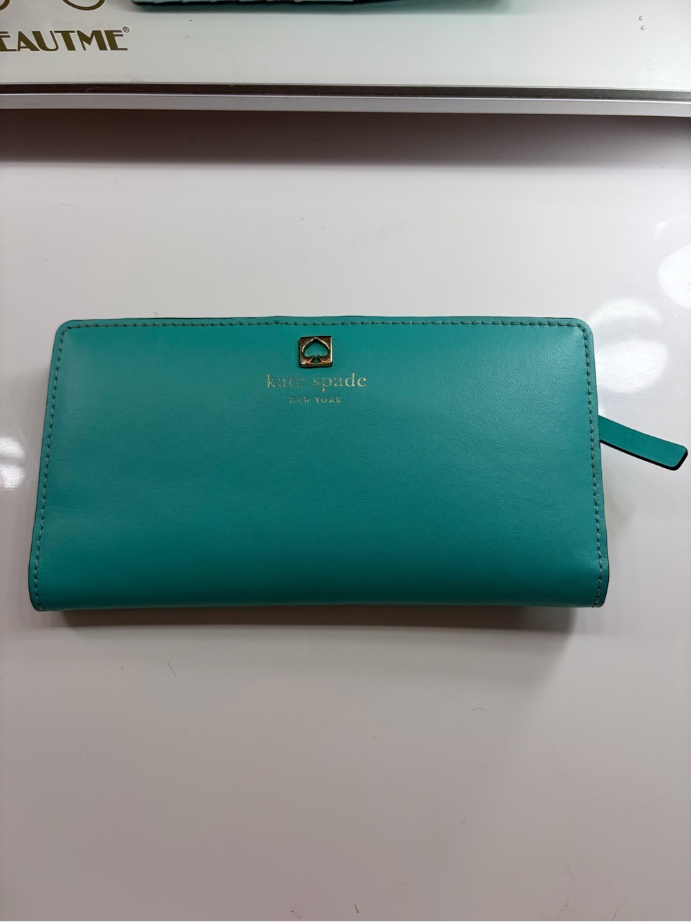 kate spade teal zip-around leather wallet with gold logo